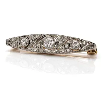 A 14K gold and platinum brooch with diamonds.