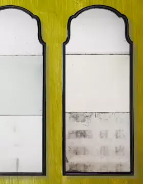 A PAIR OF EBONISED MIRRORS