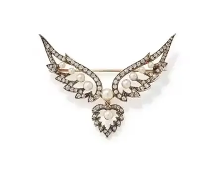 AN EARLY 20TH CENTURY PEARL AND DIAMOND WINGED HEART BROOCH