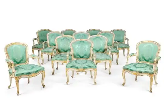 A SET OF TWELVE GEORGE III WHITE PAINTED AND PARCEL GILT ARMCHAIRS