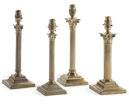 A GROUP OF FOUR POLISHED BRASS COLUMNAR TABLE LIGHTS, EARLY 20TH CENTURY