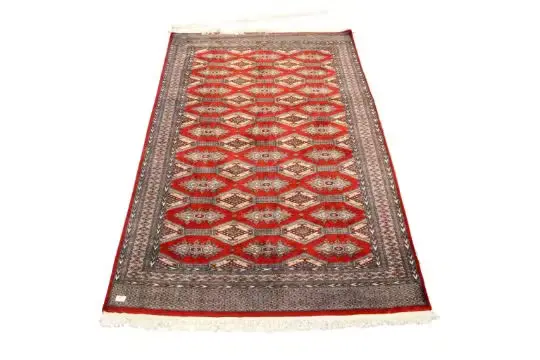 A contemporary Indian Bokhara style wool rug on a red ground.