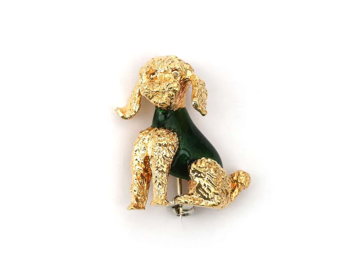 An 18-carat yellow gold brooch, enamelled in green, in the shape of a poodle