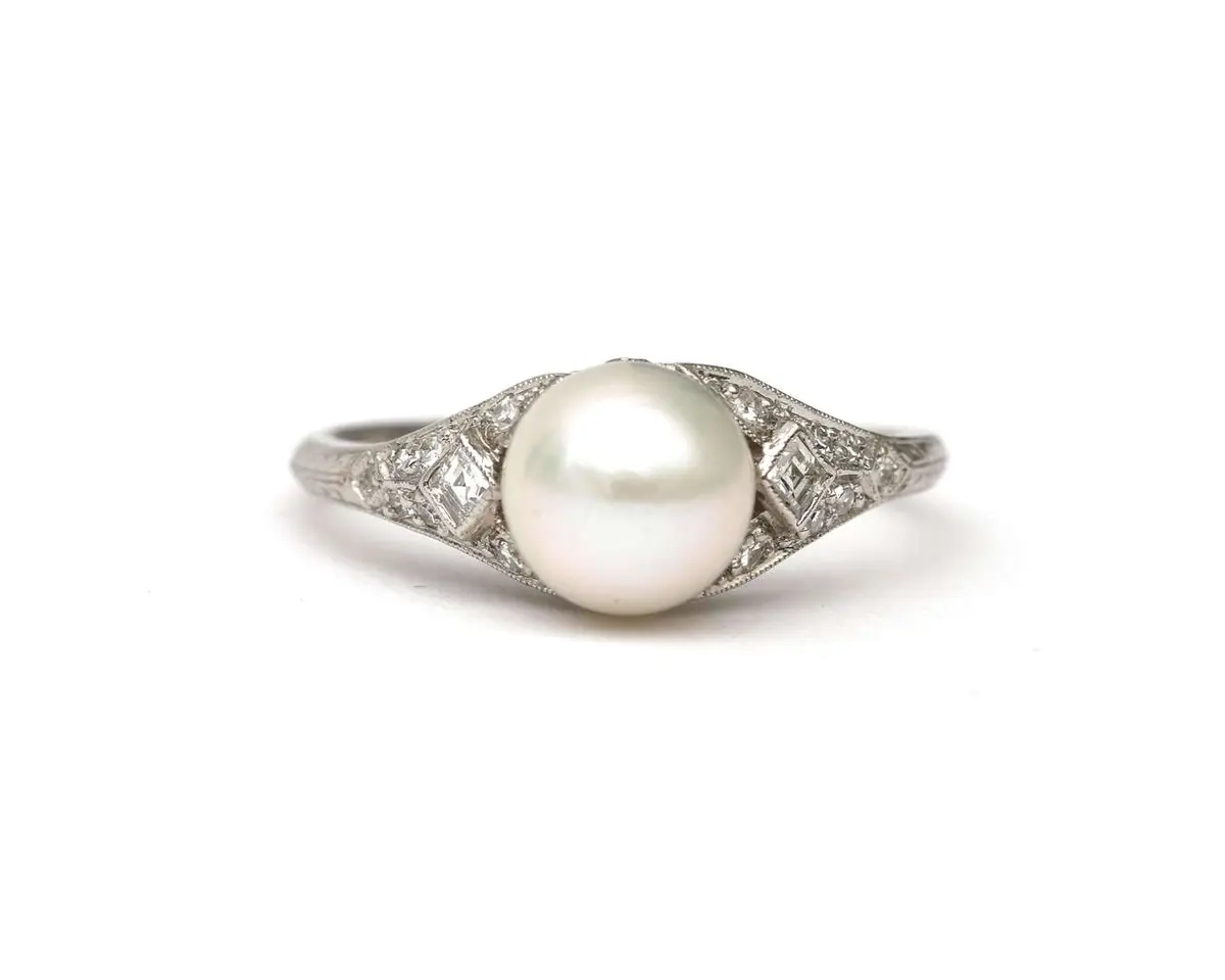 A platinum ring with a diamond and a cultured pearl