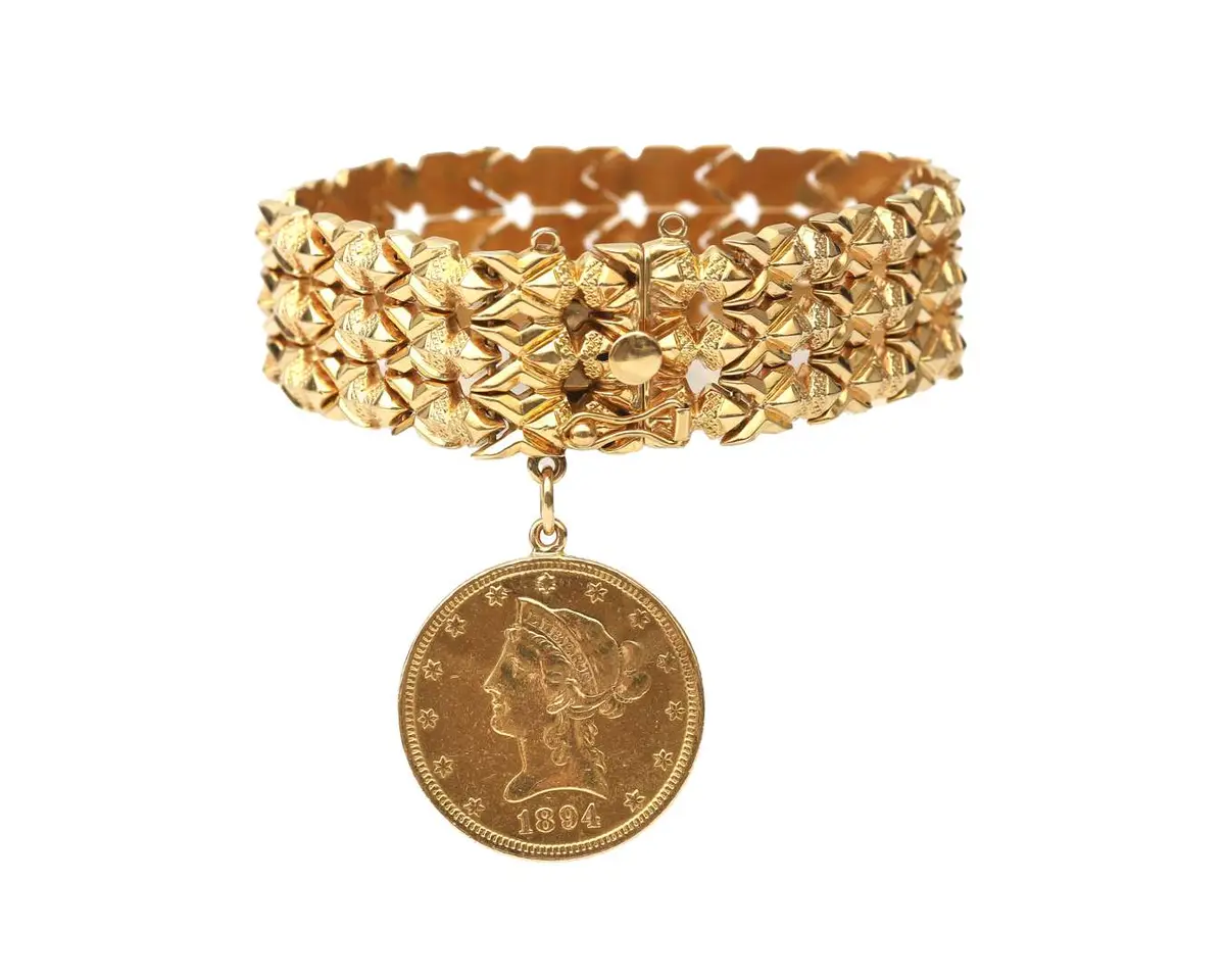 An 18-carat yellow gold bracelet with a coin pendant
