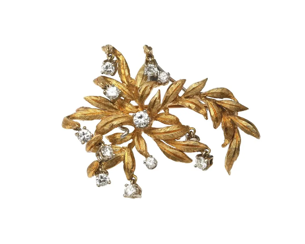 An 18-carat yellow gold floral brooch set with a diamond