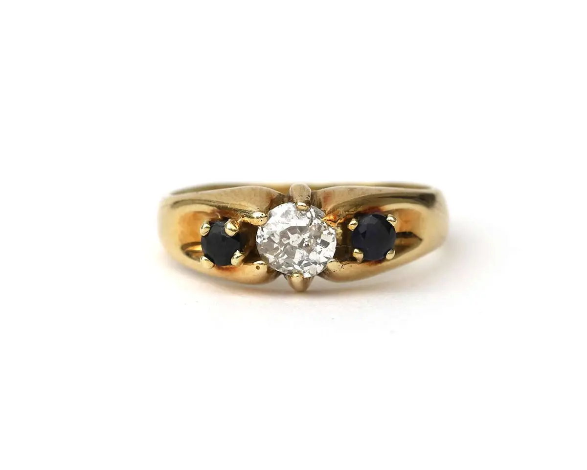A 14-carat yellow gold ring with a diamond and a sapphire