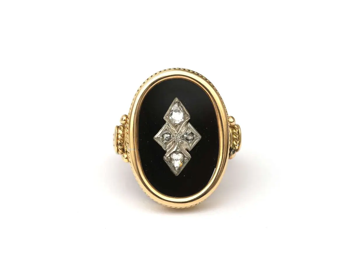 A 14k yellow gold ring with onyx and a diamond