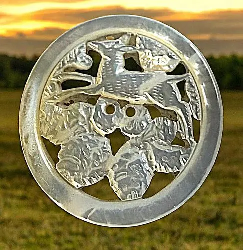 A DIVISION THREE PIERCED PICTORIAL PEARL BUTTON