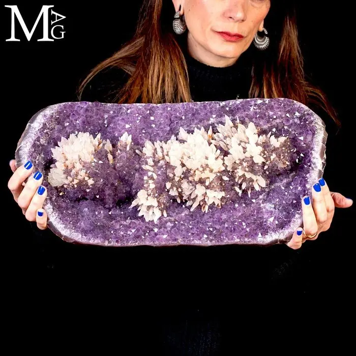 A majestic amethyst geode with snow-white quartz crystals growing inside