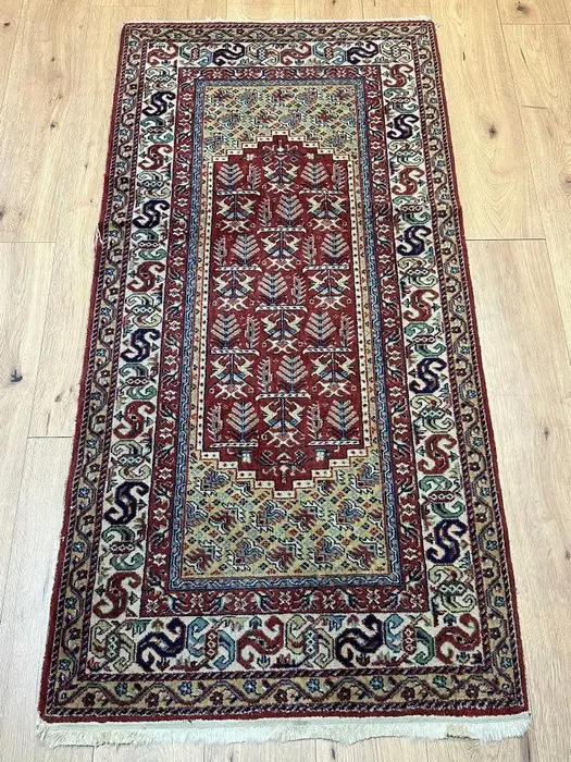 Hand-knotted Oriental rug with a traditional pattern and harmonious coloring