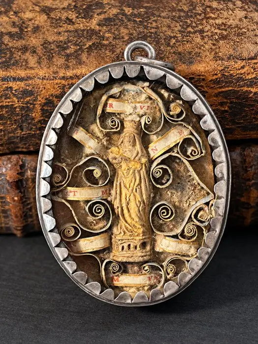 Double-sided silver reliquary pendant with multiple relics