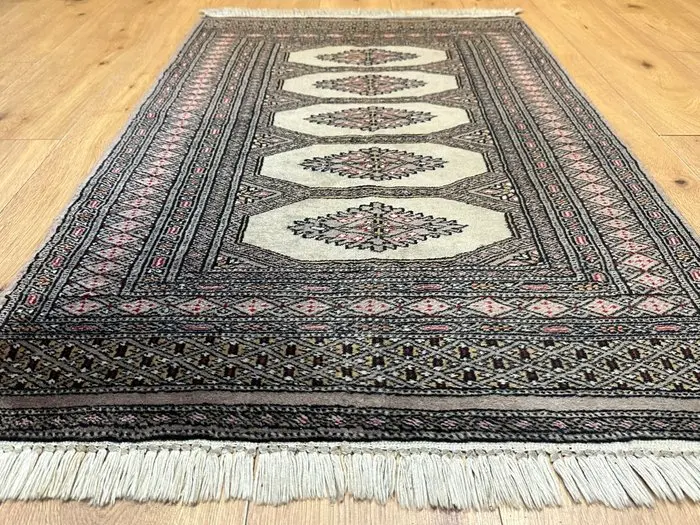 Hand-knotted Pakistan Bokhara Oriental rug with a classic...