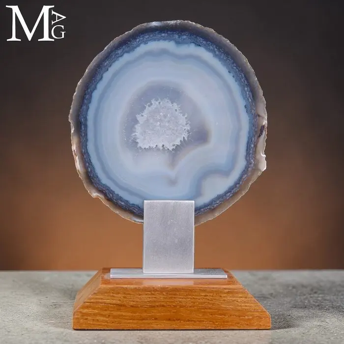Polished geode slice with a central cavity of sparkling...
