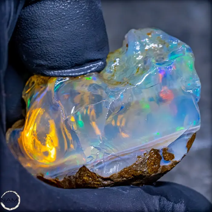 Transparent crystal opal with fascinating neon reflections 200.95 ct- 40.19 g