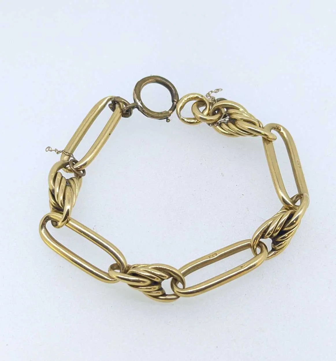 A watch chain stamped '18' with a base metal clasp