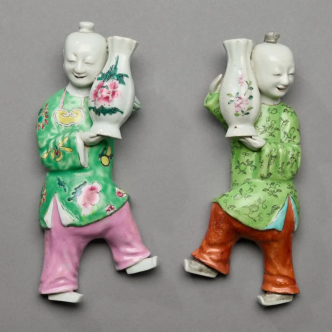 2 Figural Smiling Boy Wall Pockets