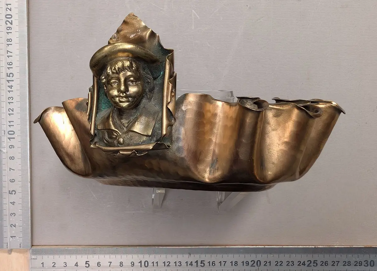 Antique fluted brass cup decorated with a child's head—see photos