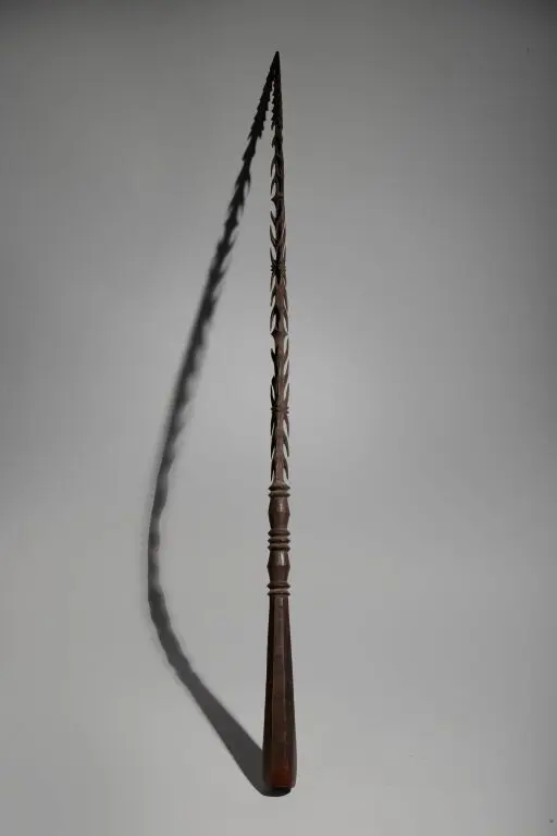 A rare hand weapon, entirely and delicately carved from a solid block