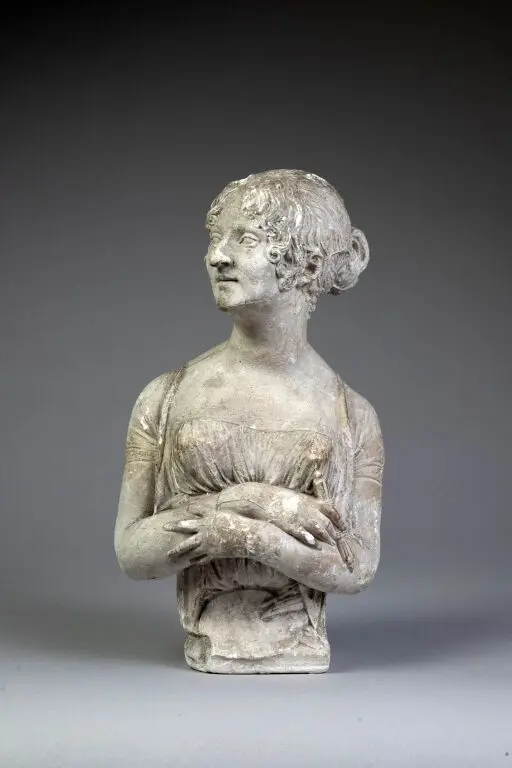 Bust portrait of a woman with her hair in a bun. Cast plaster. Signed