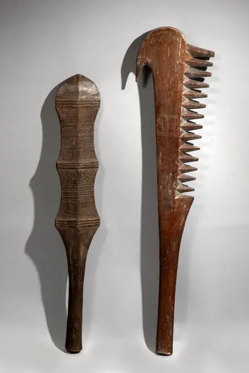 A large club with serrations of spikes on one side and a hook on the