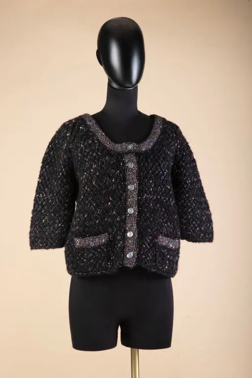 CHANEL - Cruise Collection. Collarless jacket in black wool knit with