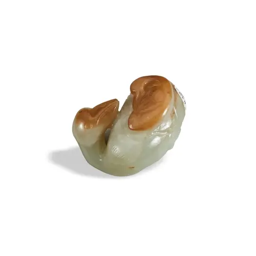 A CELADON AND RUSSET JADE GOOSE GROUP QING DYNASTY, 19TH CEN...
