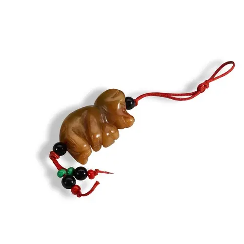 A CARVED GREEN AND RUSSET-BROWN HARDSTONE BEAR PENDANT 20TH ...