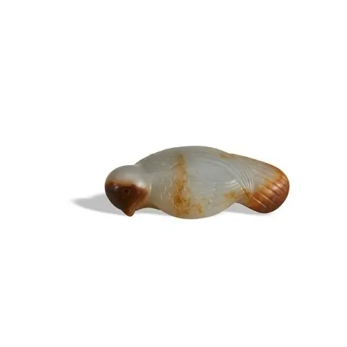 A WHITE AND MOTTLED RUSSET JADE 'BIRD' HAT FINIAL QING DYNAS...