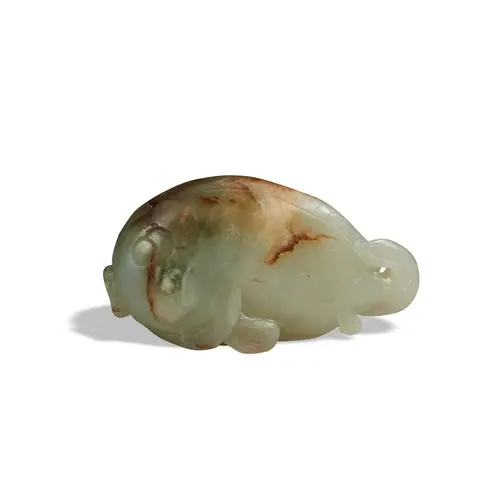 A CELADON RUSSET JADE CARVING OF A FISH QING DYNASTY, 19TH C...