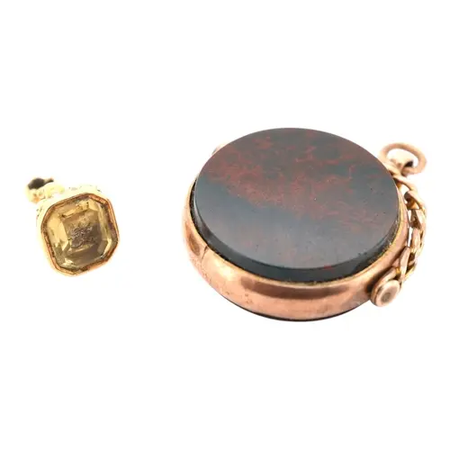 Two seals, comprising: a circular swivel fob seal set with c...