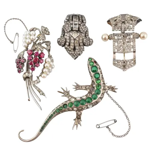 A selection of mid century white metal and silver brooches. ...