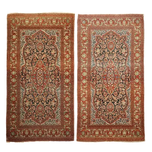 A pair of antique Ispahan blue ground rugs, early 20th centu...