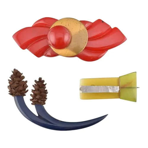 Three early plastic Art Deco brightly coloured brooch pins. ...