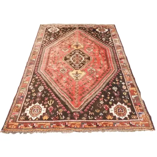A pink ground Bidjar rug with dark diamond form central meda...