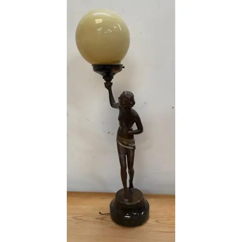 An Art Deco figural table lamp on a marble plinth with a gla...