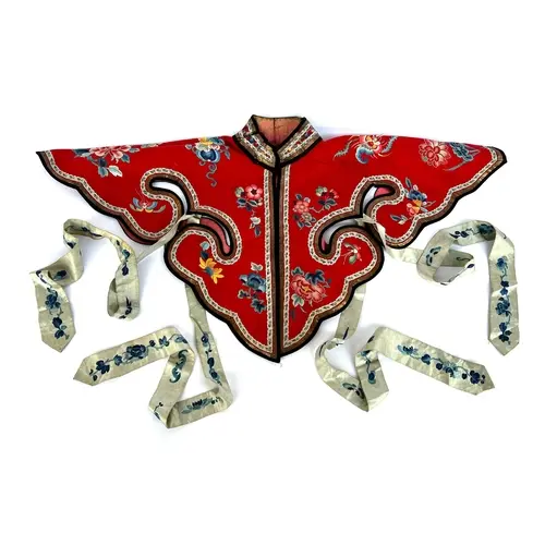 An antique Chinese theatrical silk 'cloud' collar, red silk ...