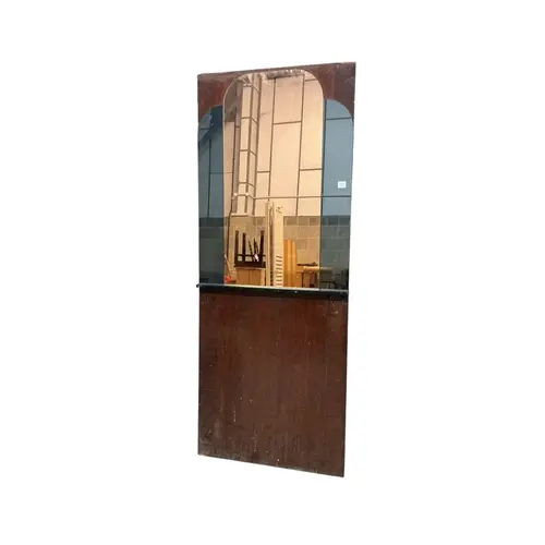 An Art Deco peach glass wall mirror mounted on a board, mir...