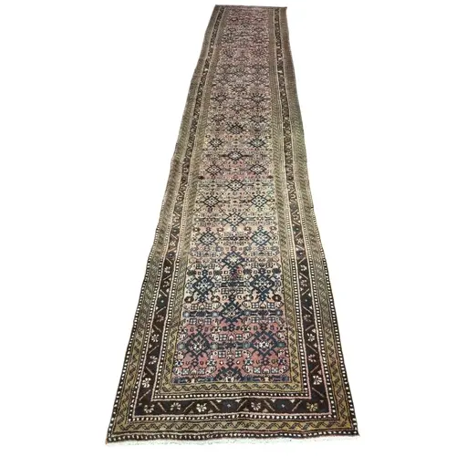 A large and impressive Persian Hamadan runner, with a washed...