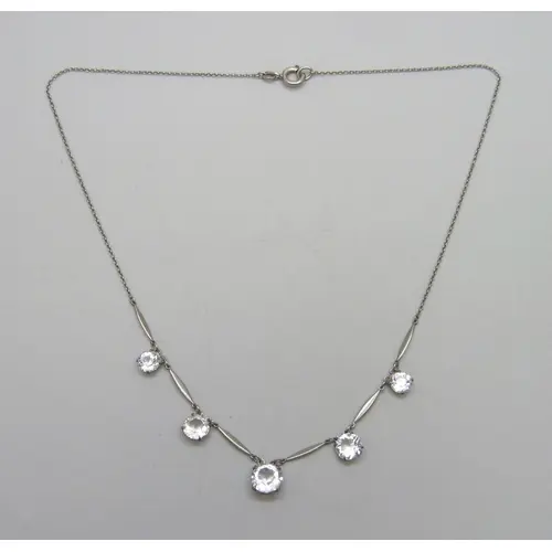 An Art Deco riviere drop necklace set with white paste stone...