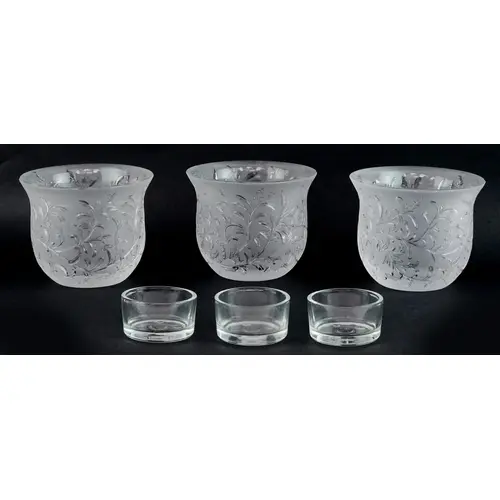 Three Lalique frosted glass tealight holders in the Rosemary...