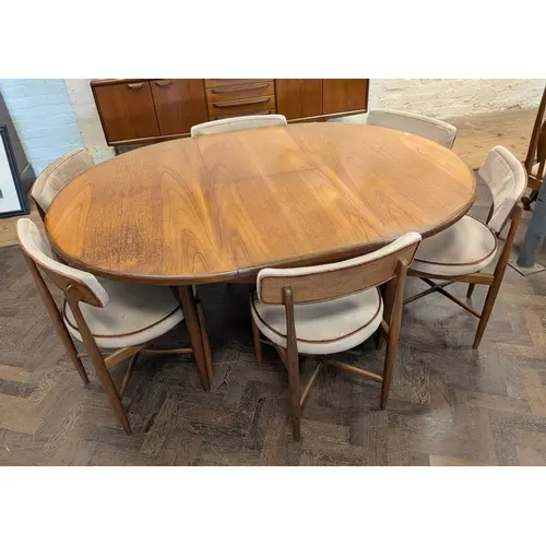 A 1960's/1970's G-plan teak oval extending dining table toge...