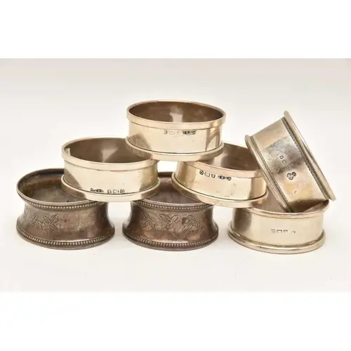 AN ASSORTMENT OF SILVER NAPKIN RINGS, seven napkin rings in ...