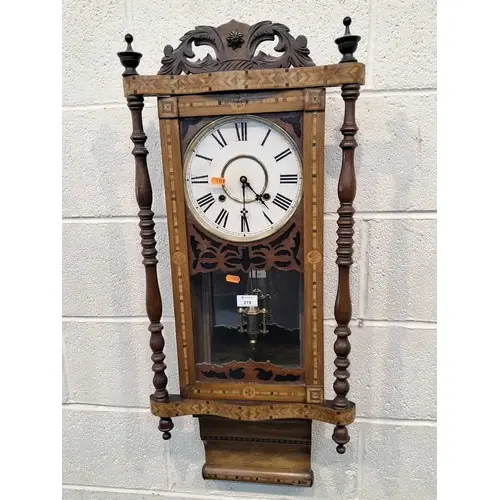 A WALNUT AND PARQUETRY WALL CLOCK, the glass door enclosing ...