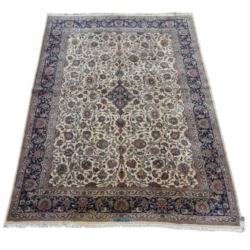 GOOD MASHAD OR KASHAN CARPET, CIRCA 1970. The ivory field of...