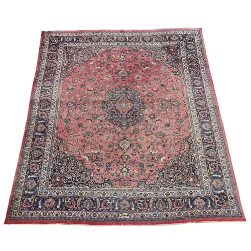 A KHORASAN CARPET. The rose pink field of scrolling vines ce...