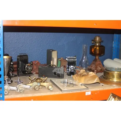 Shelf containing mixed items to include brass ships baromete...