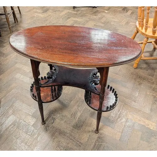 An Edwardian oval mahogany occasional table with unusual sha...