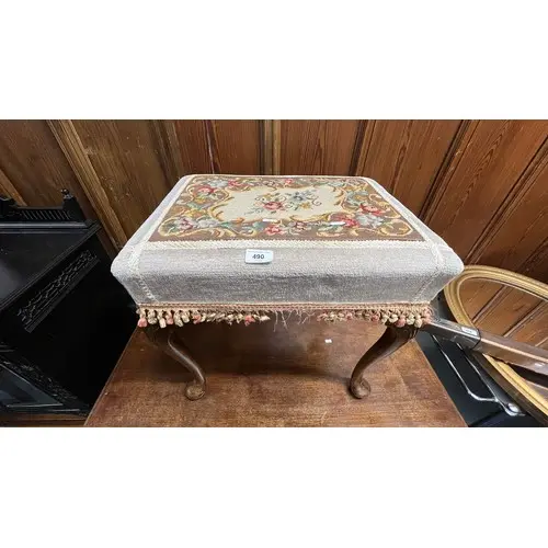 Upholstered footstool.