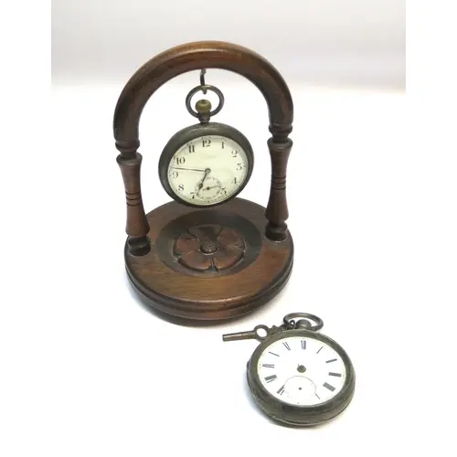 Two silver cased pocket watches, and a wooden watch stand
